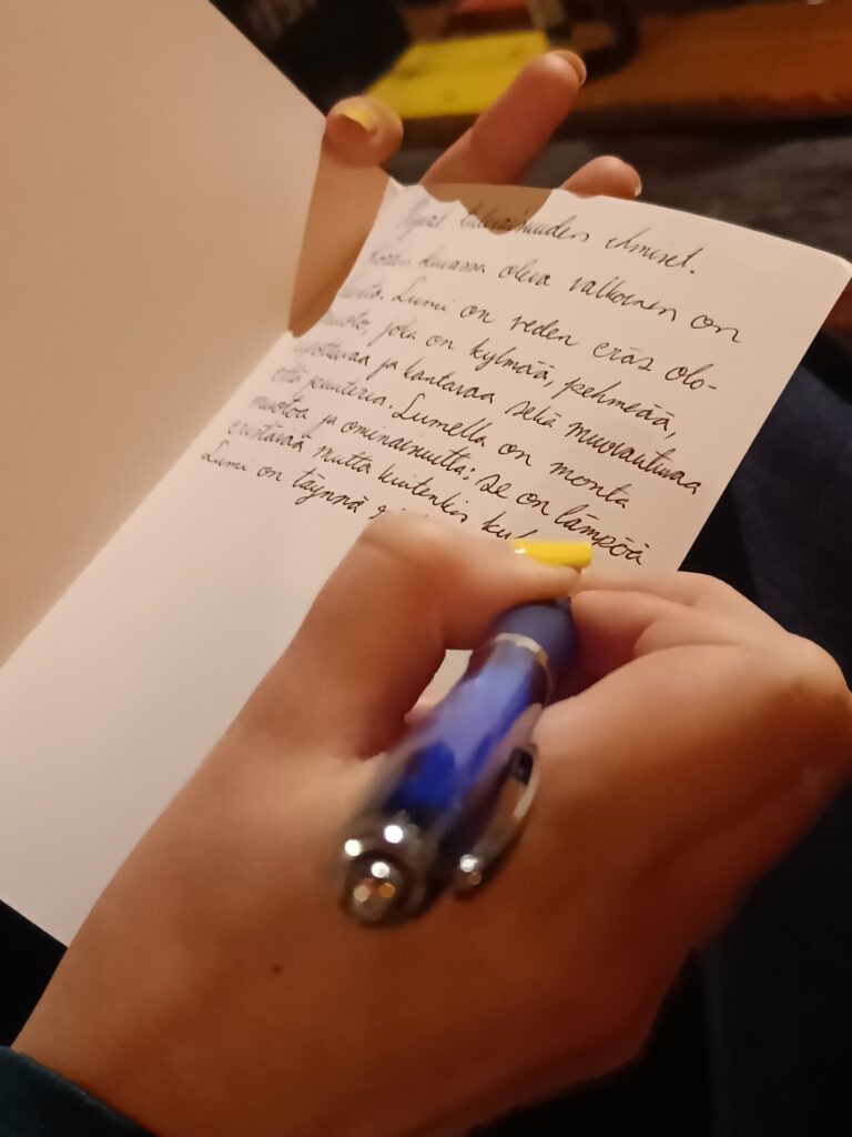 Womans hand is writing a message.